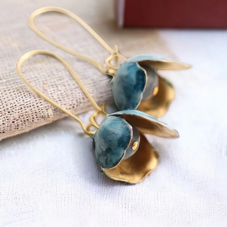 Coupe Fleurie | Boucles d'oreilles dorées avec pierre bleu-gris dans une fleur – Vue 01