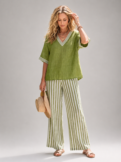 Femme portant un ensemble deux pièces avec tunique col V et pantalon large à rayures, coloris vert