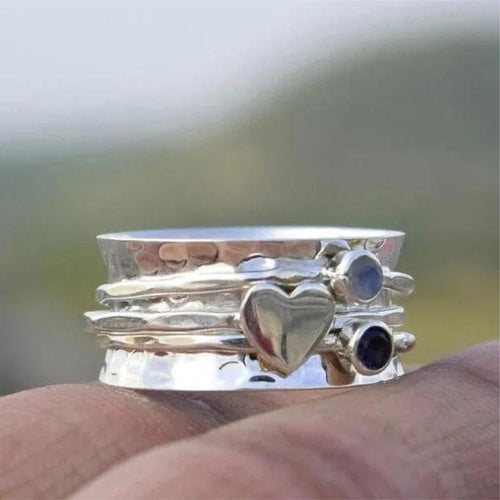 Cœur Pivotant | Bague tournante large argentée avec cœur et pierres bleues – Vue 01