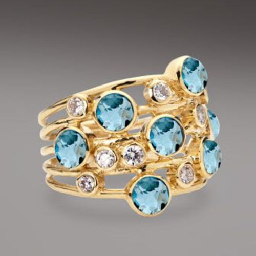 Jeu d'Eau | Bague large dorée avec pierres bleu clair et claires – Vue 01