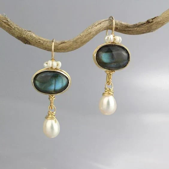 Pierre Chatoyante | Boucles d'oreilles dorées avec pierre sombre et goutte blanche – Vue 01