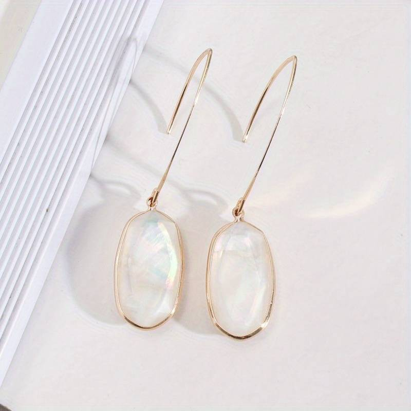 Ovale Blanc | Boucles d'oreilles dorées avec surface ovale blanche – Vue 01