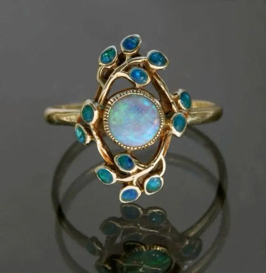 Couronne Solaire | Bague dorée avec pierre chatoyante et bordure bleue – Vue 01