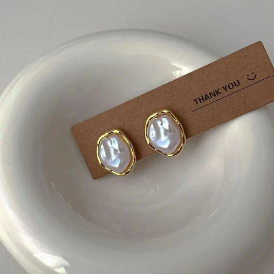 Serti Ondulé | Boucles d'oreilles dorées avec détail blanc irrégulier – Vue 01