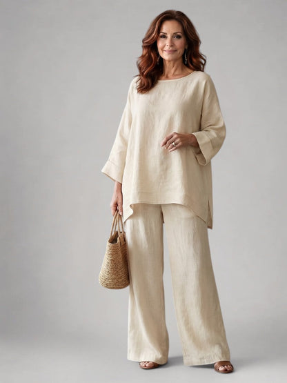 Femme portant un ensemble deux pièces avec tunique oversize et pantalon à jambes larges, coloris beige